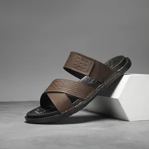 Side view detail of men's brown faux leather slides with textured straps and black sole