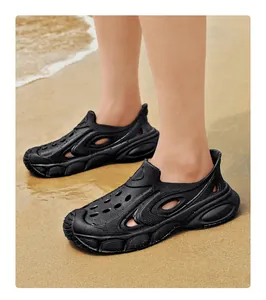 Detailed view of men's black breathable beach clogs with thick anti-slip sole on sand