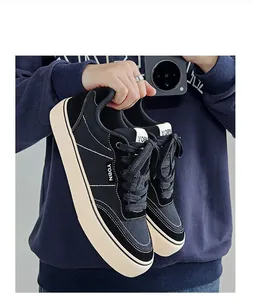Close-up of men's black canvas sneakers with vulcanized sole and white stitching