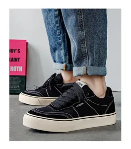 Detailed side view of black low-top men's canvas shoes with white stitching detail