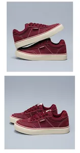 Close-up of wine red low-top canvas sneakers with vulcanized soles and white stitching