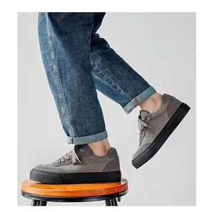 Side view of men's grey low-top canvas sneakers on model with thick black soles