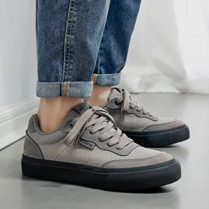 Classic men's grey low-top canvas sneakers with black vulcanized soles for daily wear