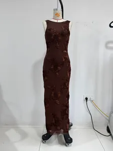 Close-up detail of a brown evening dress with exquisite 3D floral embroidery textures