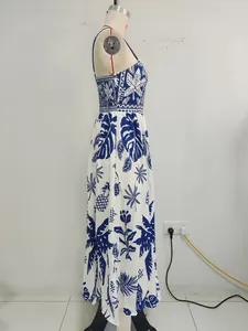 Side view detail of a blue and white tropical print maxi sundress on a mannequin