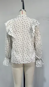 Back view detail of white ruffle long-sleeved shirt with black heart print