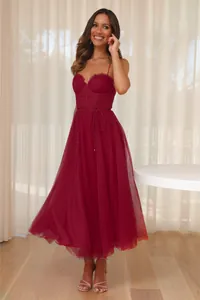 Close-up detail of a burgundy tulle midi dress with pleated corset bodice and thin straps