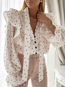 Detailed view of a white French style ruffled blouse featuring a black heart print