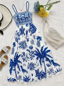 Summer vacation sundress with blue tropical patterns on white fabric and spaghetti straps