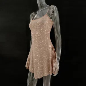 Close-up of nude semi-transparent sling mini dress with sparkling hot-fix rhinestones.