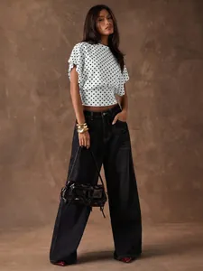 Model wearing a French vintage polka dot crop top featuring stylish batwing sleeves.