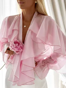 Detail shot of elegant pink ruffled chiffon blouse with bell cuffs and soft layers