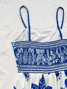 Close-up of blue and white printed summer dress featuring smocked chest and pineapple patterns.