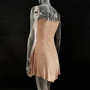 Detail view of a nude mini party dress featuring sparkling rhinestones and thin straps