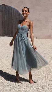 Detail of dusty blue spaghetti strap tulle dress with corset bodice for vacation.