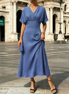 Elegant blue V-neck short-sleeved maxi dress with cinched waist shown on a model