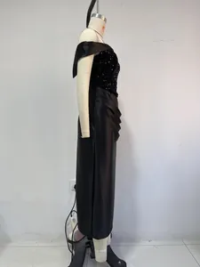 Side profile of a black sequin and satin off-shoulder evening midi dress on a mannequin