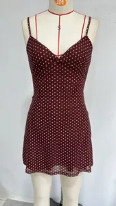 Close-up detail of a sexy wine red polka dot sleeveless mini dress on a mannequin