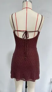 Back view of burgundy polka dot mini cami dress with tie detail on tailor dummy