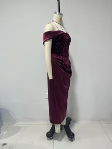 Side profile detail showing the sequin bodice and satin wrap skirt of this burgundy dress.