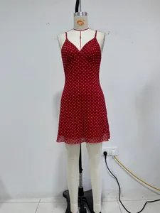 Red polka dot mini dress with v-neck and spaghetti straps on a mannequin
