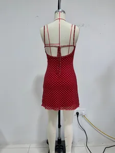 Back view of a red and white polka dot mini dress on a dress form model