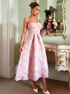 Full-length view of an elegant pink floral jacquard strapless midi dress for party wear