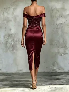 Detailed back view of a burgundy off-shoulder sequin satin midi dress with back slit