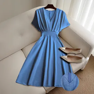 Detail view of V-neckline and back zipper on a blue short-sleeve waisted midi dress.