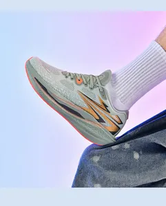 Seitenansicht graue Laufschuhe mit orangen Akzenten an Füßen mit weißen Socken