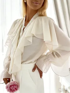 Detail of elegant white chiffon blouse with ruffles and flared sleeves for vacation