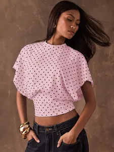 Elegant pink polka dot blouse with batwing sleeves and cinched waist for women