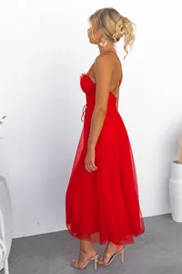 Elegant red tulle midi dress with spaghetti straps, side profile view on a model.