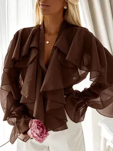 Close-up detail of a brown chiffon blouse featuring layered ruffles and elegant bell sleeves