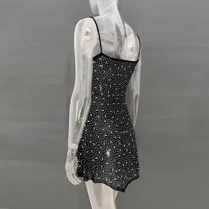 Back view detail of a black rhinestone mini dress with spaghetti straps on a clear mannequin