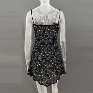 Back view of a black semi-transparent party dress with rhinestone details and thin straps