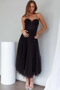 Elegant black spaghetti strap midi dress with tulle skirt and corset-style bustier top.