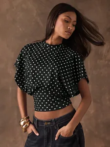 Detailed view of French retro polka dot short top featuring stylish batwing sleeves.