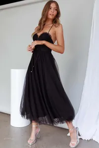 Full view of black tulle spaghetti strap midi dress with ruffled bodice and tie waist detail