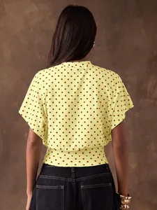 Back view of a yellow French vintage polka dot cropped blouse with batwing sleeves