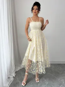 Detailed view of white mesh daisy print midi dress with smocked bodice design