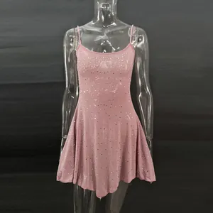 Close-up of a pink party dress with hot-fix rhinestones and thin shoulder straps.