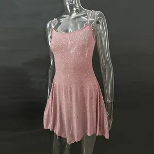 Macro detail of sparkling silver rhinestones on a pink semi-transparent mini party dress
