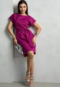 Full-length detail shot of fuchsia short-sleeved dress featuring waist-tie and silver accessories