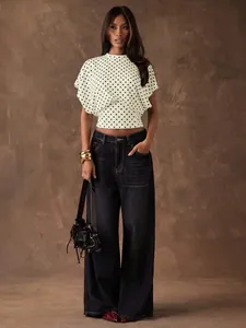 Elegant white polka dot cropped blouse featuring batwing sleeves and a high neck design