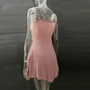 Back view of a pink rhinestone party dress with semi-sheer fabric and spaghetti straps