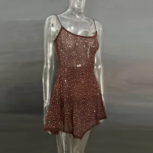 Detail of brown sheer party dress with shimmering rhinestones and spaghetti straps