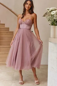 Elegant dusty rose tulle midi dress with corset bodice and spaghetti straps on model