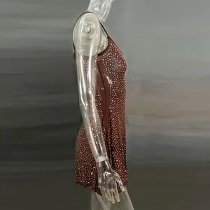 Side view detail of a brown rhinestone sheer mini slip dress for party wear.
