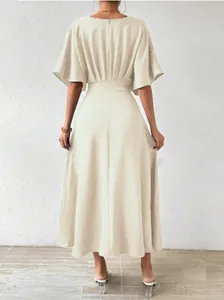 Back view of elegant beige mid-length dress featuring cinched waist and flutter sleeves.